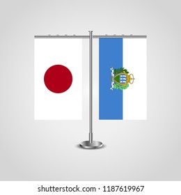 Table stand with flags of Japan and San marino.Two flag. Flag pole. Symbolizing the cooperation between the two countries. Table flags