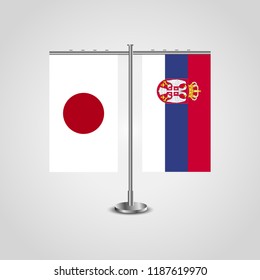 Table stand with flags of Japan and Serbia.Two flag. Flag pole. Symbolizing the cooperation between the two countries. Table flags