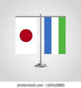 Table stand with flags of Japan and Sierra Leone.Two flag. Flag pole. Symbolizing the cooperation between the two countries. Table flags