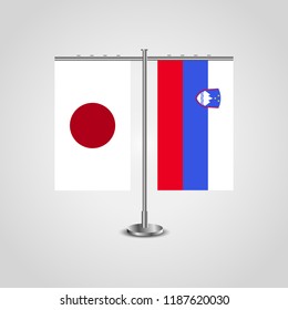 Table stand with flags of Japan and Slovenia.Two flag. Flag pole. Symbolizing the cooperation between the two countries. Table flags