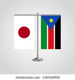 Table stand with flags of Japan and Southern Sudan.Two flag. Flag pole. Symbolizing the cooperation between the two countries. Table flags