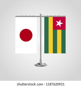 Table stand with flags of Japan and Togo.Two flag. Flag pole. Symbolizing the cooperation between the two countries. Table flags