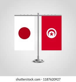 Table stand with flags of Japan and Tunisia.Two flag. Flag pole. Symbolizing the cooperation between the two countries. Table flags