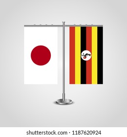Table stand with flags of Japan and Uganda.Two flag. Flag pole. Symbolizing the cooperation between the two countries. Table flags