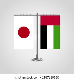 Table stand with flags of Japan and United Arab Emirates.Two flag. Flag pole. Symbolizing the cooperation between the two countries. Table flags