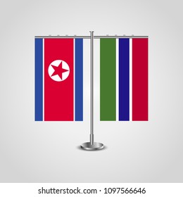 Table stand with flags of North Korea and Gambia.Two flag. Flag pole. Symbolizing the cooperation between the two countries. Table flags