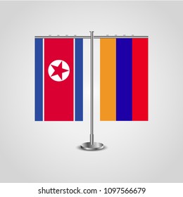 Table stand with flags of North Korea and Armenia.Two flag. Flag pole. Symbolizing the cooperation between the two countries. Table flags