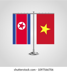 Table stand with flags of North Korea and Vietnam.Two flag. Flag pole. Symbolizing the cooperation between the two countries. Table flags