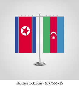 Table stand with flags of North Korea and Azerbaijan.Two flag. Flag pole. Symbolizing the cooperation between the two countries. Table flags