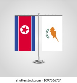 Table stand with flags of North Korea and Cyprus.Two flag. Flag pole. Symbolizing the cooperation between the two countries. Table flags