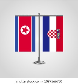 Table stand with flags of North Korea and Croatia.Two flag. Flag pole. Symbolizing the cooperation between the two countries. Table flags