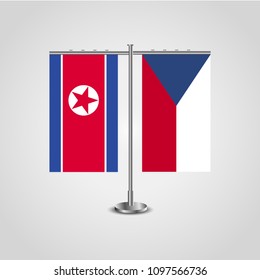 Table stand with flags of North Korea and Czech Republic.Two flag. Flag pole. Symbolizing the cooperation between the two countries. Table flags