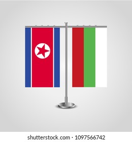 Table stand with flags of North Korea and Bulgaria.Two flag. Flag pole. Symbolizing the cooperation between the two countries. Table flags
