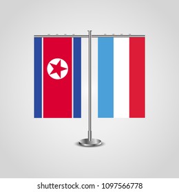 Table stand with flags of North Korea and Luxembourg.Two flag. Flag pole. Symbolizing the cooperation between the two countries. Table flags