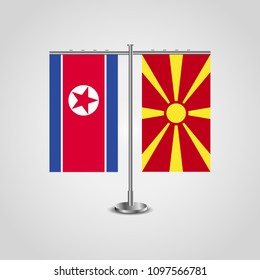 Table stand with flags of North Korea and Macedonia.Two flag. Flag pole. Symbolizing the cooperation between the two countries. Table flags