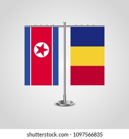 Table stand with flags of North Korea and Romania.Two flag. Flag pole. Symbolizing the cooperation between the two countries. Table flags