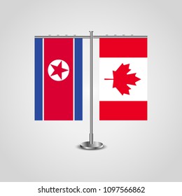 Table stand with flags of North Korea and Canada.Two flag. Flag pole. Symbolizing the cooperation between the two countries. Table flags