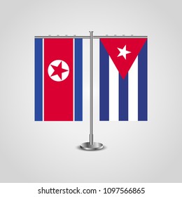 Table stand with flags of North Korea and Cuba.Two flag. Flag pole. Symbolizing the cooperation between the two countries. Table flags