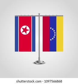 Table stand with flags of North Korea and Venezuela.Two flag. Flag pole. Symbolizing the cooperation between the two countries. Table flags