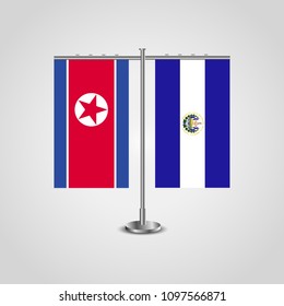 Table stand with flags of North Korea and El Salvador.Two flag. Flag pole. Symbolizing the cooperation between the two countries. Table flags