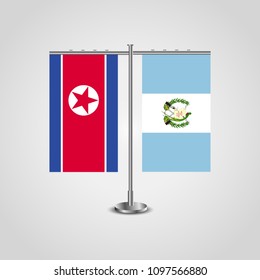 Table stand with flags of North Korea and Guatemala.Two flag. Flag pole. Symbolizing the cooperation between the two countries. Table flags