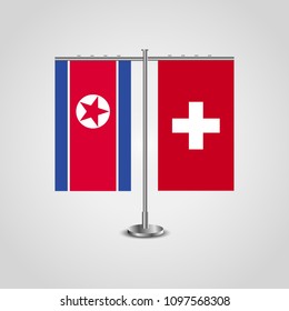 Table stand with flags of North Korea and Switzerland.Two flag. Flag pole. Symbolizing the cooperation between the two countries. Table flags