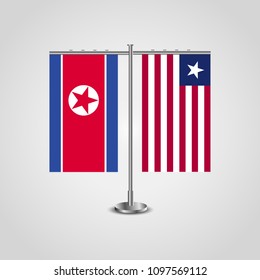 Table stand with flags of North Korea and Liberia.Two flag. Flag pole. Symbolizing the cooperation between the two countries. Table flags