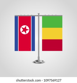 Table stand with flags of North Korea and Mali.Two flag. Flag pole. Symbolizing the cooperation between the two countries. Table flags