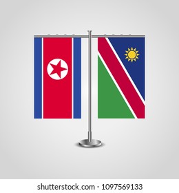 Table stand with flags of North Korea and Namibia.Two flag. Flag pole. Symbolizing the cooperation between the two countries. Table flags