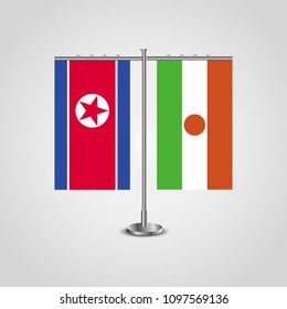 Table stand with flags of North Korea and Niger.Two flag. Flag pole. Symbolizing the cooperation between the two countries. Table flags