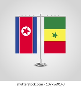 Table stand with flags of North Korea and Senegal.Two flag. Flag pole. Symbolizing the cooperation between the two countries. Table flags