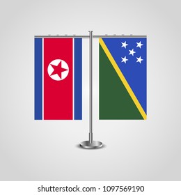 Table stand with flags of North Korea and Solomon islands.Two flag. Flag pole. Symbolizing the cooperation between the two countries. Table flags