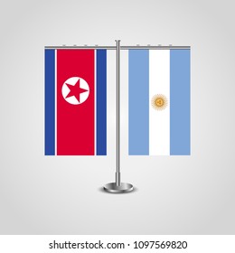 Table stand with flags of North Korea and Argentina.Two flag. Flag pole. Symbolizing the cooperation between the two countries. Table flags