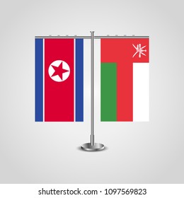 Table stand with flags of North Korea and Oman.Two flag. Flag pole. Symbolizing the cooperation between the two countries. Table flags