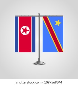 Table stand with flags of North Korea and Democratic Republic of the Congo.Two flag. Flag pole. Symbolizing the cooperation between the two countries. Table flags