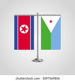 Table stand with flags of North Korea and Djibouti.Two flag. Flag pole. Symbolizing the cooperation between the two countries. Table flags