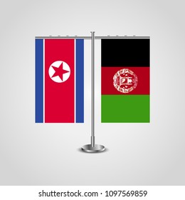 Table stand with flags of North Korea and Afghanistan.Two flag. Flag pole. Symbolizing the cooperation between the two countries. Table flags