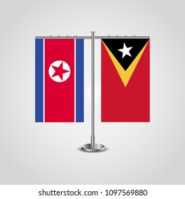 Table stand with flags of North Korea and East Timor.Two flag. Flag pole. Symbolizing the cooperation between the two countries. Table flags