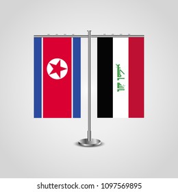 Table stand with flags of North Korea and Iraq.Two flag. Flag pole. Symbolizing the cooperation between the two countries. Table flags