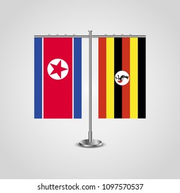 Table stand with flags of North Korea and Uganda.Two flag. Flag pole. Symbolizing the cooperation between the two countries. Table flags