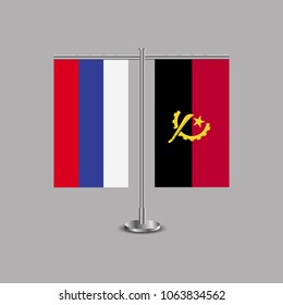 Table stand with flags of Russia and Angola.Two flag. Flag pole. Symbolizing the cooperation between the two countries.Table flags