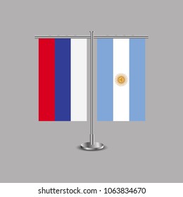 Table stand with flags of Russia and Argentina.Two flag. Flag pole. Symbolizing the cooperation between the two countries.Table flags