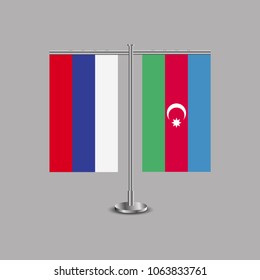 Table stand with flags of Russia and Azerbaijan.Two flag. Flag pole. Symbolizing the cooperation between the two countries.Table flags