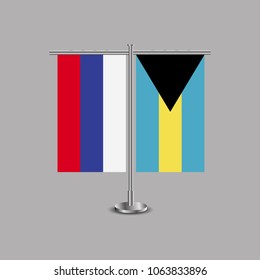 Table stand with flags of Russia and The Bahamas.Two flag. Flag pole. Symbolizing the cooperation between the two countries.Table flags