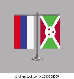 Table stand with flags of Russia and Burundi.Two flag. Flag pole. Symbolizing the cooperation between the two countries.Table flags