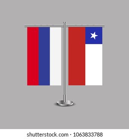 Table stand with flags of Russia and Chile.Two flag. Flag pole. Symbolizing the cooperation between the two countries.Table flags