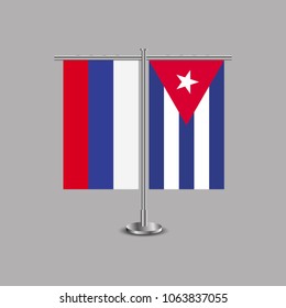 Table stand with flags of Russia and Cuba.Two flag. Flag pole. Symbolizing the cooperation between the two countries.Table flags