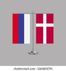 Table stand with flags of Russia and Denmark.Two flag. Flag pole. Symbolizing the cooperation between the two countries.Table flags