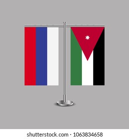 Table stand with flags of Russia and Jordan.Two flag. Flag pole. Symbolizing the cooperation between the two countries.Table flags