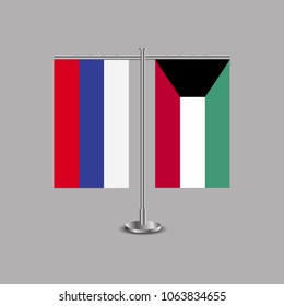 Table stand with flags of Russia and Kuwait.Two flag. Flag pole. Symbolizing the cooperation between the two countries.Table flags